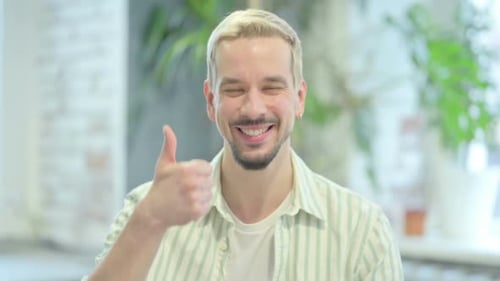 Young Adult Man Gives Thumbs Up to Camera