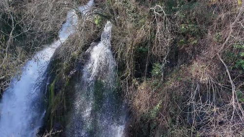 Above View Of Foamy Flowing Streams Of Fervenza Da Noveira Waterfall Over Granite Rock Formation In