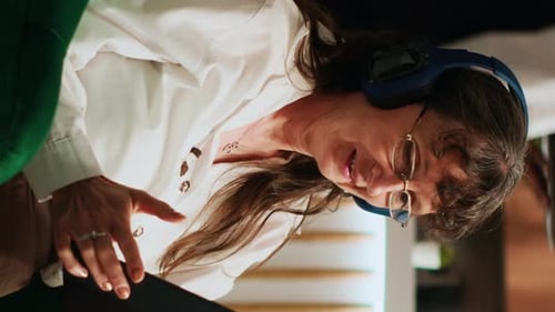 Woman Using Tablet Wearing Headphones Indoors