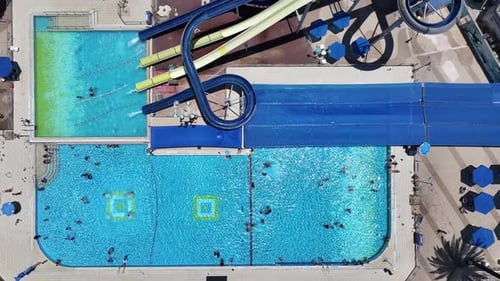 Aerial view of people sliding down a water slide at a water park