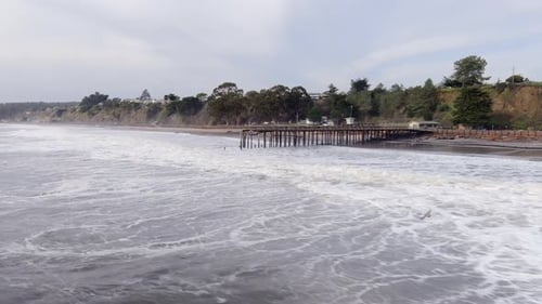 Aerial, pier at Seacliff State beach destroyed by flooding storm surge caused by climate change