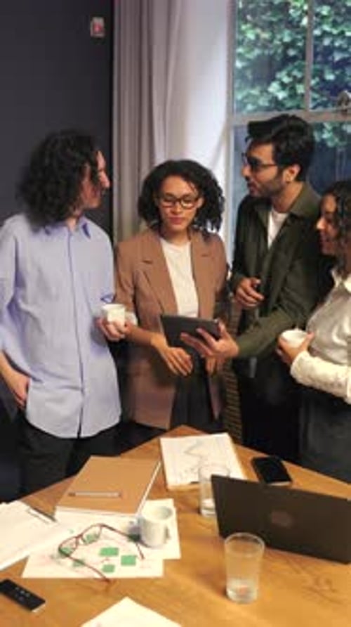 Group of Professionals Engaging in Energetic Strategic Planning Discussion in Modern Office