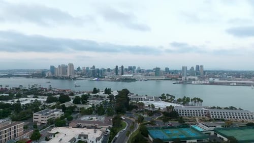 Aerial view of downtown San Diego in the distance across San Diego Bay. Flying above the North Islan