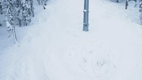 Skier on Snowy Slope with Chairlift