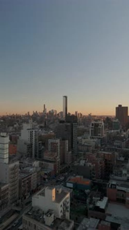 Vertical Aerial View Showcasing the New York City Skyline at Sunset Camera Pans Across the Cityscape