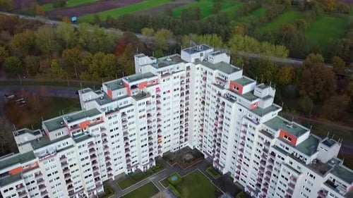 Aerial view of high rising residential apartment block complex in rural suburb of german city during