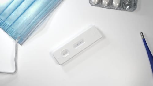 Positive Covid-19 Test, Mask, Pills and Thermometer