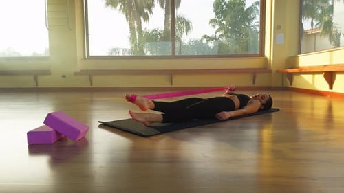 Woman Using Resistance Band for Leg Stretches