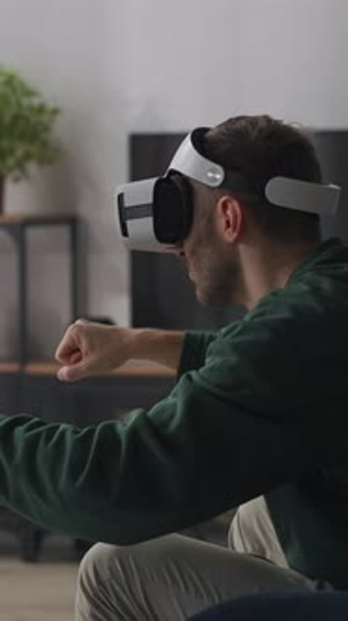 Man Immersed in Virtual Reality Gaming at Home
