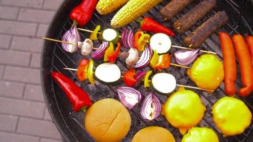 Delicious shish kebab meat and vegetables roasting on brazier grill outdoors