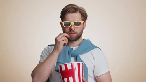 Man With 3D Glasses and Popcorn Watching Movie