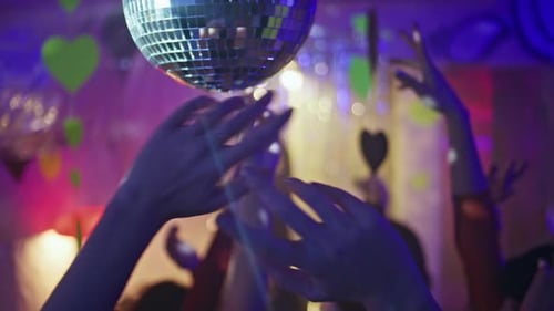 Enthusiastic Celebration Underneath Twinkling Disco Ball