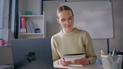 Smart Woman Conducting Online Lesson Looking Laptop Screen at Classroom Closeup