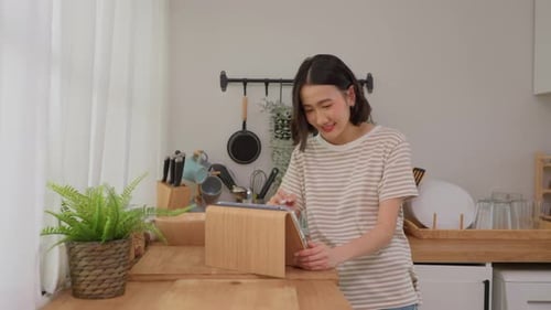 Woman Using Tablet in Bright Modern Kitchen