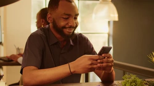 Portrait of Employee Working on Smartphone App at Startup Job