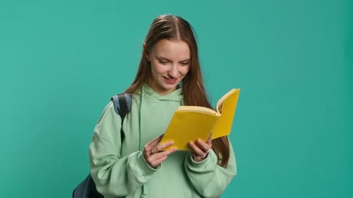 Young Girl Reading Book Enjoying Hobby Being Entertained