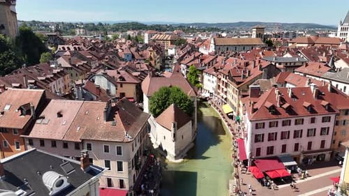 Drone footage of Palais de l'Ile, a historic island building in Annecy, France