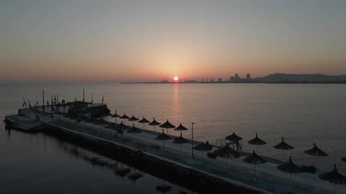 Sunset aerial flyover: Public jetty on Adriatic Sea in Durres, Albania