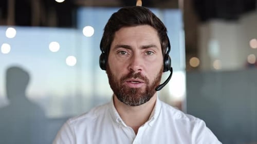 Businessman in Headset Having Video Call in Office