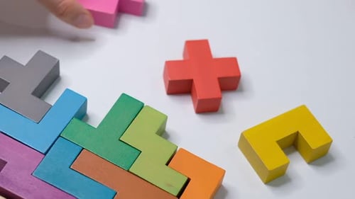Closeup Slow Motion Hand Holding Piece of Wooden Block Puzzle Wood Cube Stacking Concept of Complex
