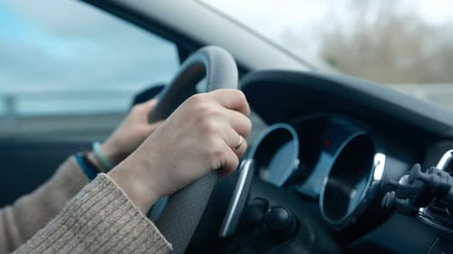 Hands on Steering Wheel Driving Car
