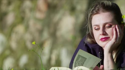 Woman Reading Book Outdoors in Spring Grass