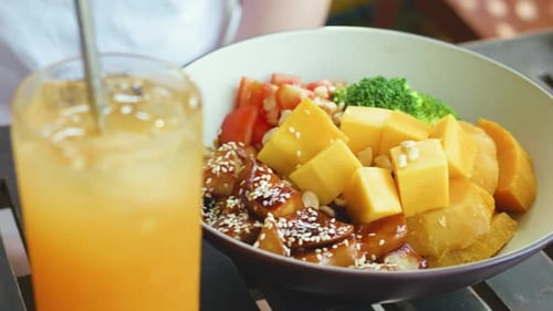 Bowl of Chicken Teriyaki with Mango and Drink