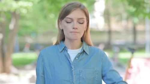 Woman Waiting Outside in an Urban Park