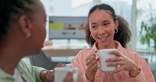 Women Drinking Coffee and Talking Indoors