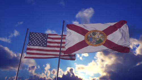 Waving American and Florida State Flags in Blue Sky