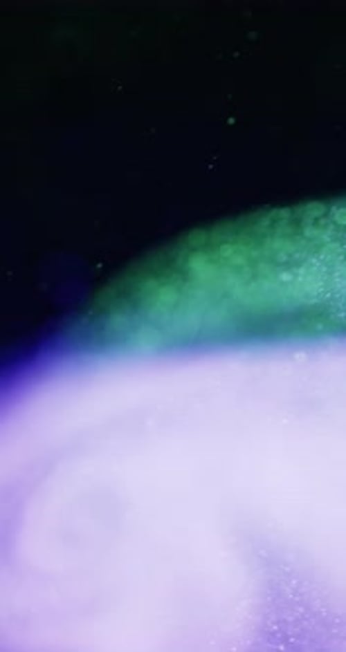 Violet And Green Bokeh Swirling In Darkness