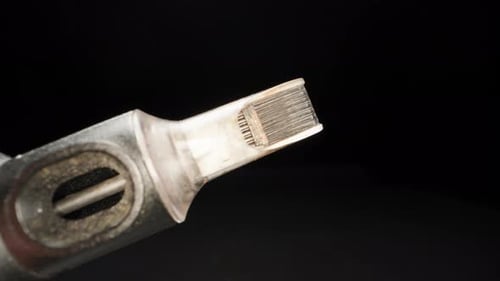 Needles for a tattoo machine, close-up. On a black background.