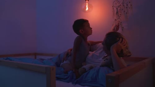 Woman and Child in Bed Under Light