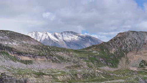 daytime mountain landscape dynamic slow stable wide aerial drone shot in alpine environment and mood