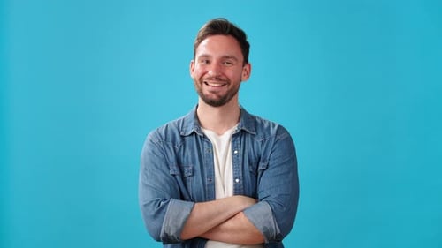 Man Smiling and Making OK Gesture on Blue