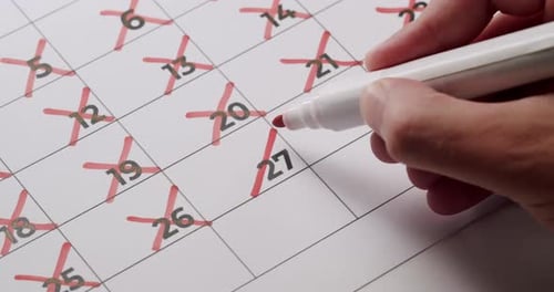 Calendar Dates Marked Off with Red Marker