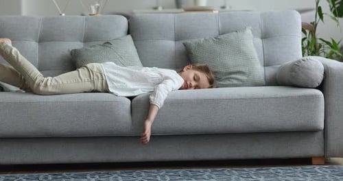 Child Lying Down on Comfortable Couch