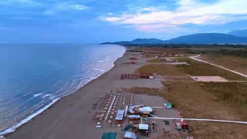 Empty beach with few people at the coast of the Adriatic Sea.
