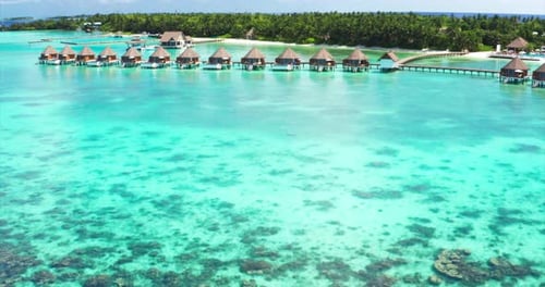 Aerial view of a scenic landscape of island with tourist luxury resort with white sand beach and c