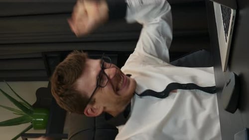 Successful man excited with good results on financial market. Vertical video