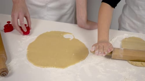 Two People Making Cookies at Home