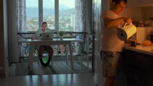 Modern Apartment Scene, Working and Preparing Beverage