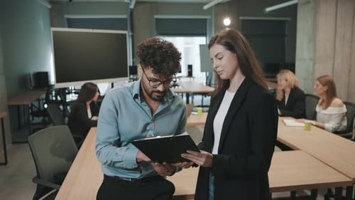 Team collaborates in office space with slow motion document review and discussion