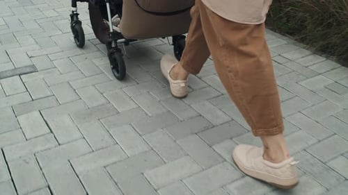 Unrecognizable Woman With Baby In Stroller