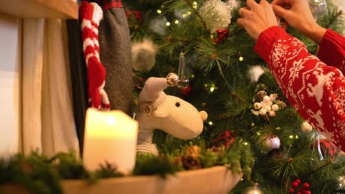 Decorating Christmas Tree With Ornaments At Home