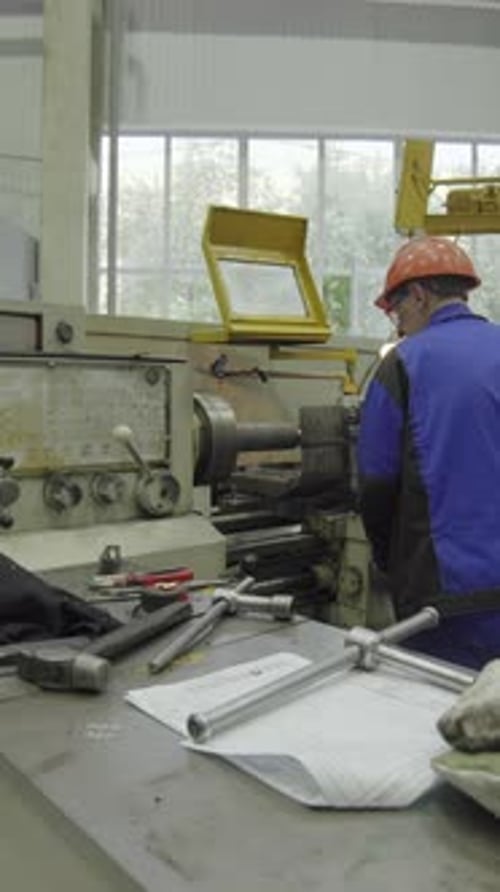 Industrial Worker Operating Lathe Machine in Factory Stock Clip