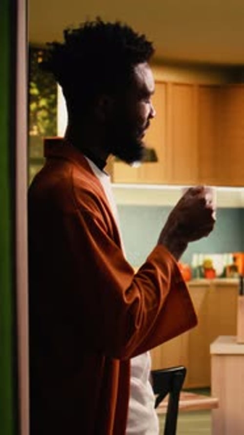Man Drinks Coffee at Home