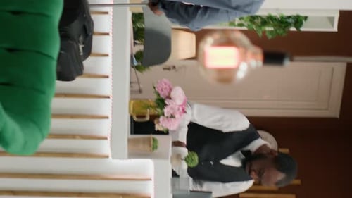 Helpful Hotel Receptionist Assists Guest at Check In