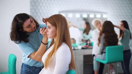 Makeup Artist Applying Makeup in Beauty Salon