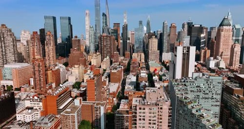Bright sun lighting the facades of multistoried buildings and skyscrapers of New York.